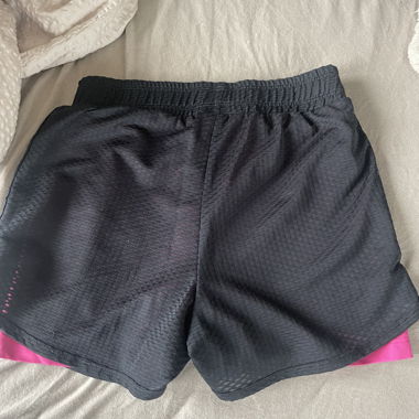Sports trousers with tight pink leggings underneath