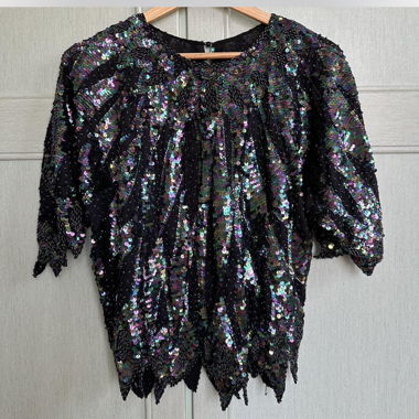 black shirt with meticulously hand-sewn sequins