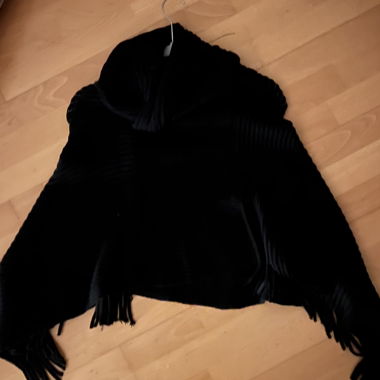 Black knitted poncho with fringes