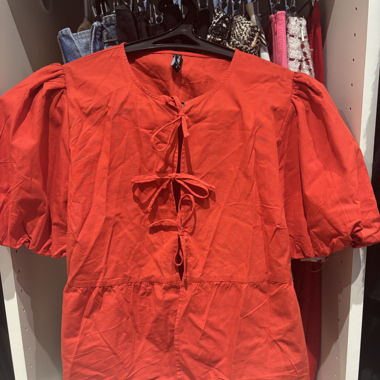 Blusa rossa con fiocco davanti