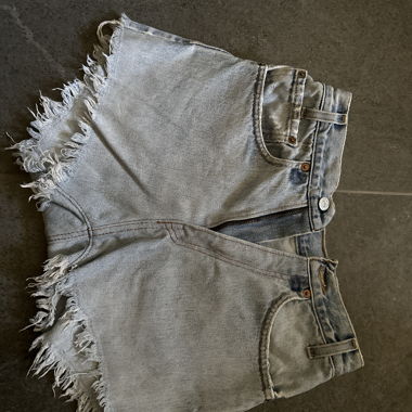 High-waist denim shorts with raw edges