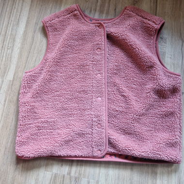 Sleeveless vest, lightly worn.