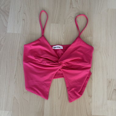 Pink crop top with deep neckline and open bottom
