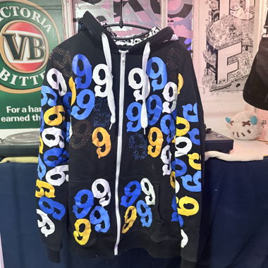 Black zip-up hooded jacket with large number 9 motif