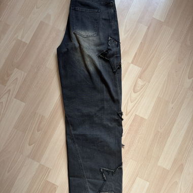 Jeans neri con patch a stella