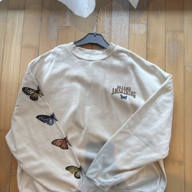 beige sweatshirt with butterflies