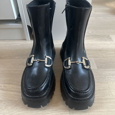Black boots with gold buckle