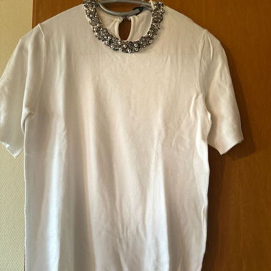 White top adorned with pearls