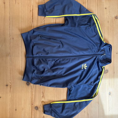 Giacca da allenamento Adidas blu con righe gialle 