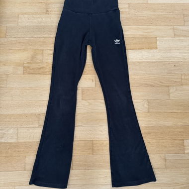 schwarze adidas-Hose mit ausgestellten Beinen