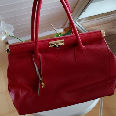 Red leather handbag with gold fittings