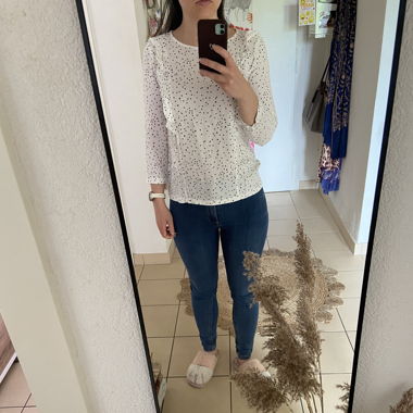 White blouse with black and red stars