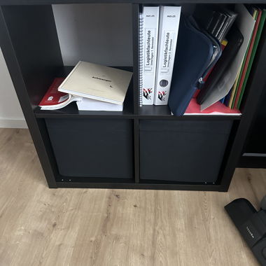 Black shelf with boxes