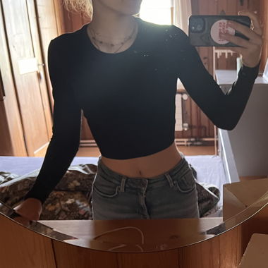 Black long-sleeve crop top with lace-up back
