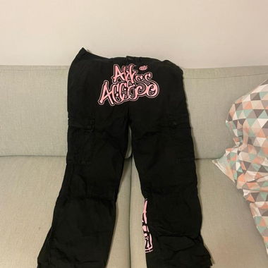 Black cargo pants with pink print by All Access