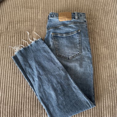 Blue women's jeans with frayed hem