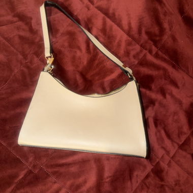 Beige shoulder bag with black handle