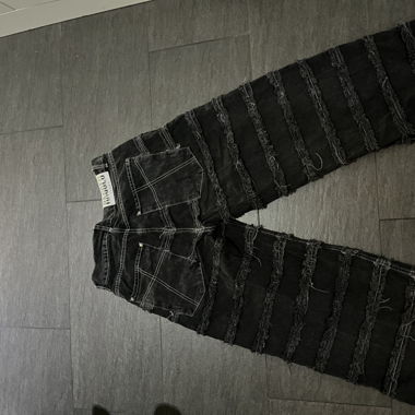 Jeans baggy strappati