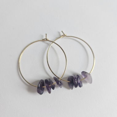Golden hoop earrings with violet stones