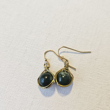 Gold-colored drop earrings with green stone