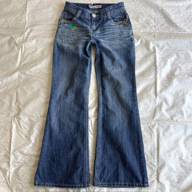 Jeans bootcut a vita bassa con occhielli dorati e strass