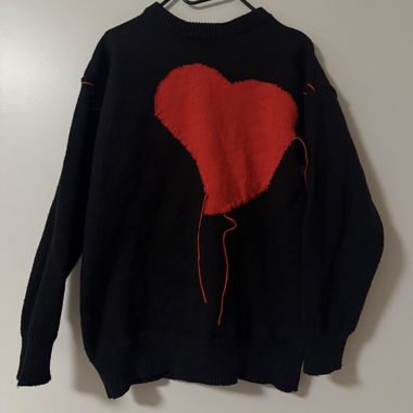 Black sweater with red heart motif