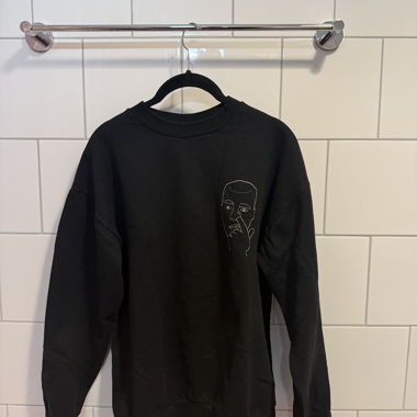 Black crewneck sweatshirt with white face design