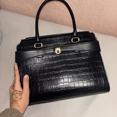 Black handbag with crocodile pattern