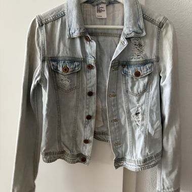 Light-wash denim jacket with rips