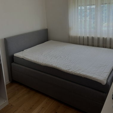 Gray upholstered boxspring bed 180x200 cm