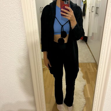 Long black sweater with pom poms