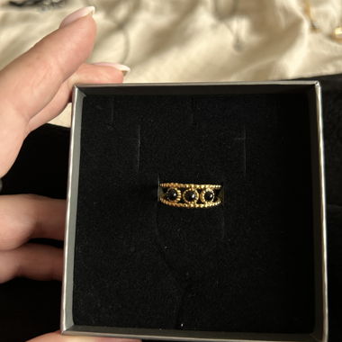 Gold ring adorned with black stones