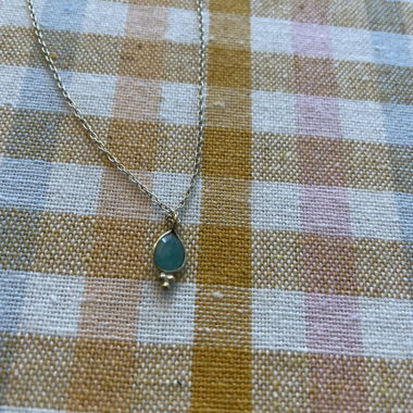 Gold-colored necklace with turquoise pendant