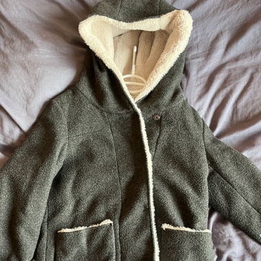 coat with white fur details