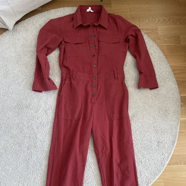 red denim jumpsuit with a belt