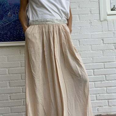 Long pale pink skirt with shinny waist. Kilibbi