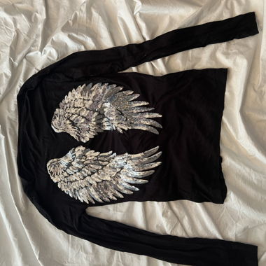 Top ali con paillettes nero
