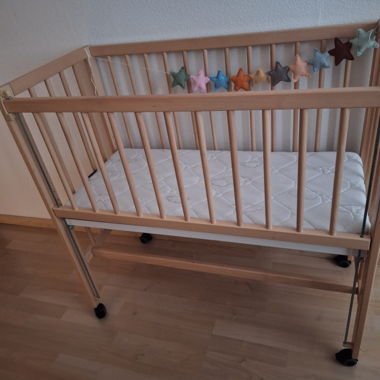Wooden baby crib with mattress