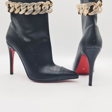 Black ankle boots with red soles