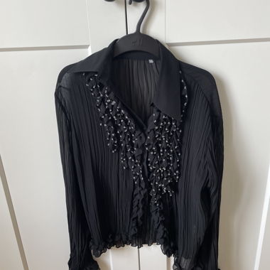 Black pleated blouse with ruffles