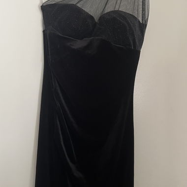 Long black velvet dress with fitted sequinned bustier and transparent tulle panel on one shoulder