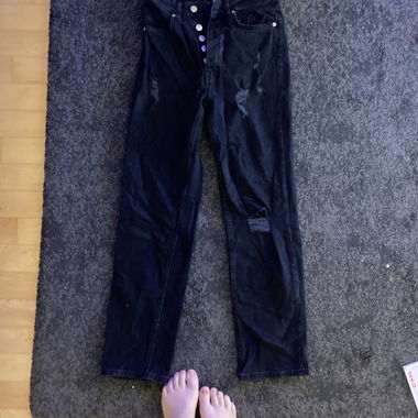 Jeans neri con bottoni sul davanti