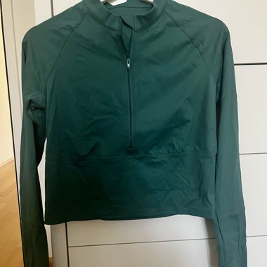Haut de sport vert avec fermeture éclair