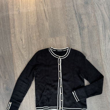 Elegant black cardigan with white detailing 