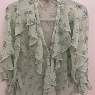 Light green ruffled blouse with floral pattern