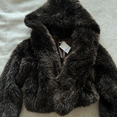 Dark brown fur with hood