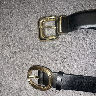 2 black belts with golden buckle