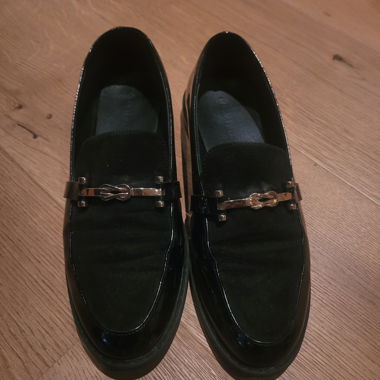 Black loafers with metal detail