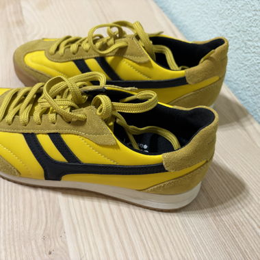 Yellow sneakers with black stripes
