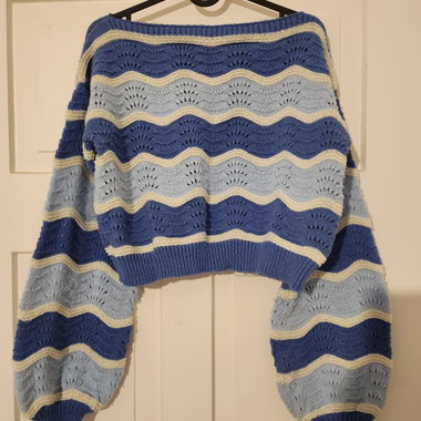 Blue knitted sweater with wave pattern